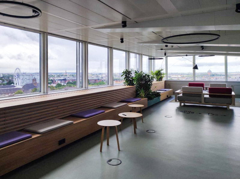 View along a bench seat by the glass façade of the slashwhy office